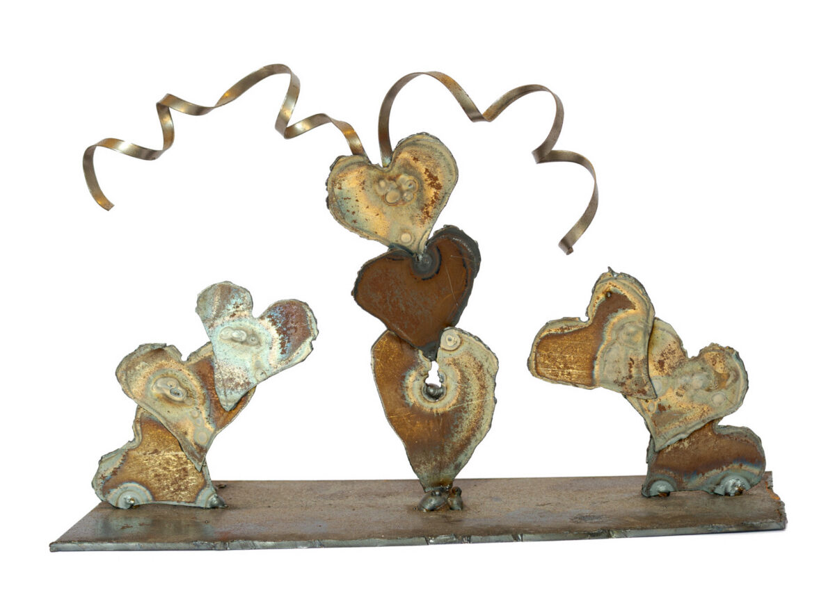Freestanding hand-welded steel sculpture by Afatasi featuring clustered heart forms connected by curling ribbon-like strips on a rectangular metal base.